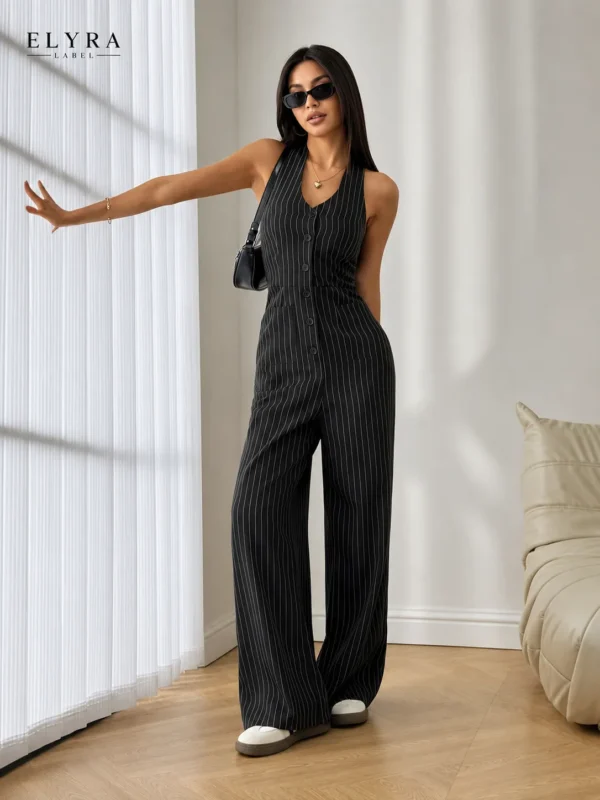 Black Pinstripe Wide Leg Jumpsuit by ELYRA LABEL featuring a sleeveless V-neck design, front button closure, tailored fit, and elegant wide-leg silhouette