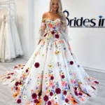 Floral Off Shoulder Prom Gown by ELYRA LABEL featuring a sweetheart neckline, colorful floral embroidery, detachable sheer sleeves, and an elegant A-line tulle silhouette