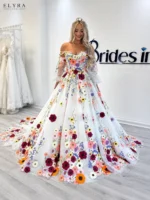 Floral Off Shoulder Prom Gown by ELYRA LABEL featuring a sweetheart neckline, colorful floral embroidery, detachable sheer sleeves, and an elegant A-line tulle silhouette
