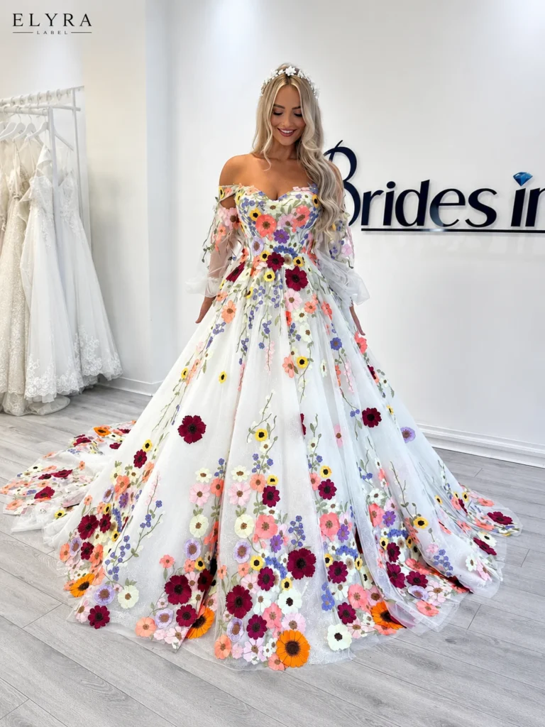 Floral Off Shoulder Prom Gown by ELYRA LABEL featuring a sweetheart neckline, colorful floral embroidery, detachable sheer sleeves, and an elegant A-line tulle silhouette